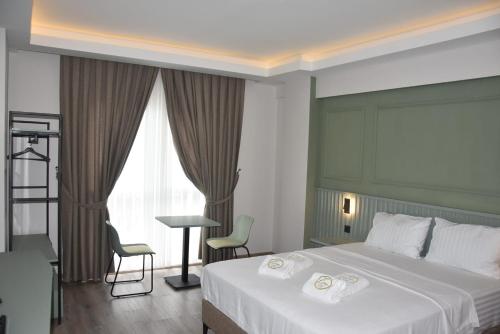 a hotel room with a bed with two towels on it at Görele Liva Otel in Görele