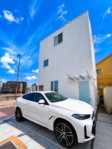 a white car parked in front of a building at Villa Monica EAST in Nagoya