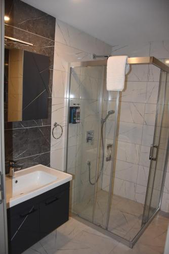 a bathroom with a shower and a sink at Görele Liva Otel in Görele