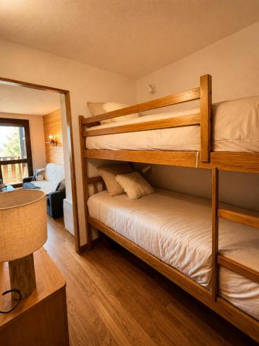 a bedroom with two bunk beds in a room at Cozy studio balcon et parking in Font-Romeu