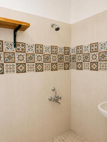 a bathroom with a shower with a sink at Bhumika by evaddo stays in Mandrem
