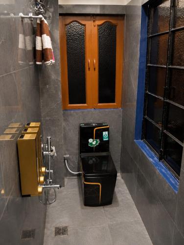 a bathroom with a toilet in a room at Veena Vihar Homestay in Jodhpur