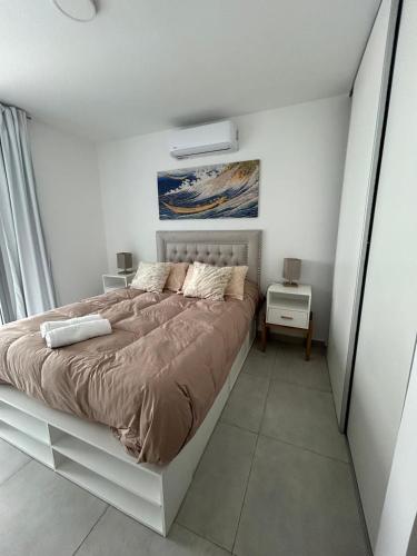 a bedroom with a large bed in a white room at Torres al mar 10 in Monte Hermoso