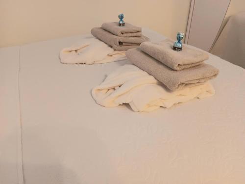 three towels sitting on a table in a bathroom at Studio Leilighet in Moss