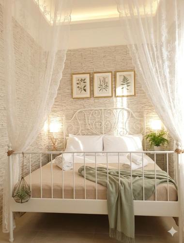 a bedroom with a white bed with a curtain at DREAM HOUSE in Naples