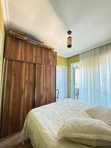 a bed with a wooden headboard in a bedroom at kobuleti Apartment in Kobuleti