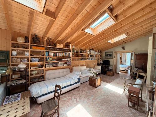 a living room with a couch and bookshelves at beachhousebarn in Vendays-Montalivet