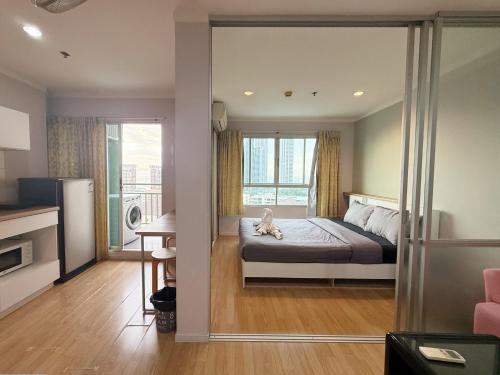 a bedroom with a bed with a dog laying on it at lumpini naklua wongamat in North Pattaya