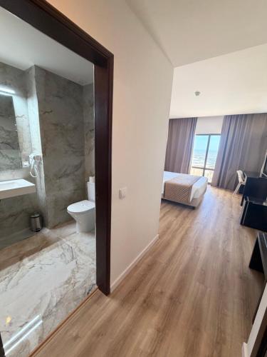 a bathroom with a sink and a toilet in a room at Hotel Atlantida Sol in Figueira da Foz