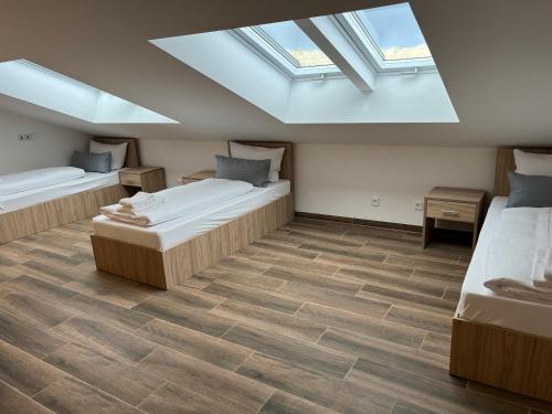 a bedroom with two beds and a skylight at Boardinghouse MDS in Aschheim