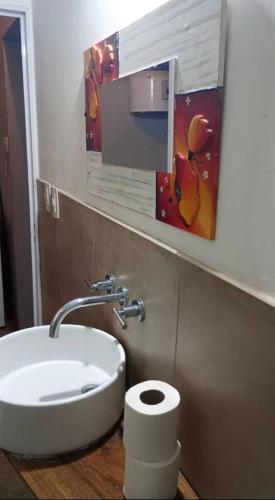 a bathroom with a white sink and a toilet at Quincho Paysandu in Arroyo Seco