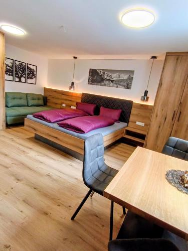 a bedroom with a bed and a dining table at Haus Gstrein in Oetz