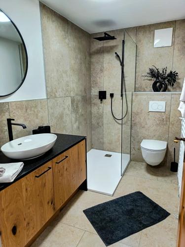 a bathroom with a shower and a sink and a toilet at Haus Gstrein in Oetz