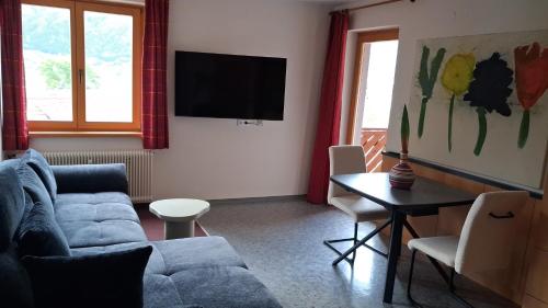 a living room with a couch and a table at Merlschober, Ferienwohnung 3, Ossiacher See in Ossiach