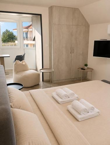 a bedroom with a bed with two towels on it at Apartments Provence in Sozopol