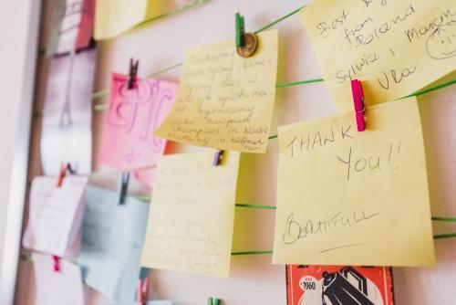 a bunch of notes hanging on a wall at MOOKI Country Apartment in Villach