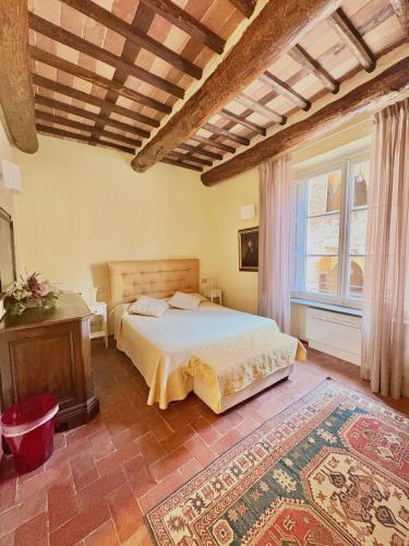 a bedroom with a bed and a large window at Antica Residenza Dell'Angelo in Lucca