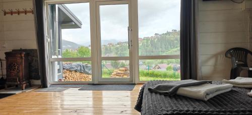 a bedroom with a large glass door with a view at Hotel Osher in Bukovel