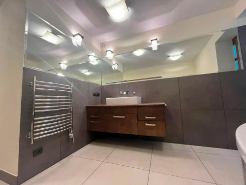 a bathroom with a sink and a mirror at Oaza Spokoju in Gdynia