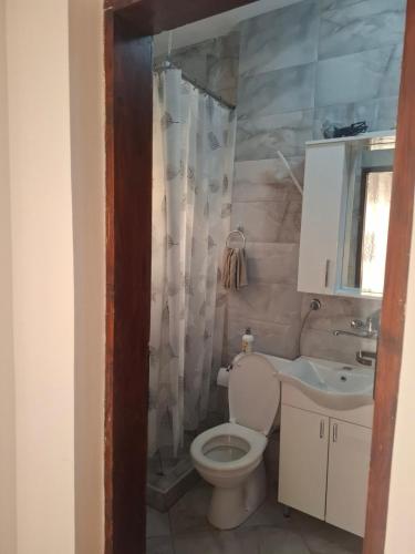 a bathroom with a toilet and a sink at Harmony in Budva