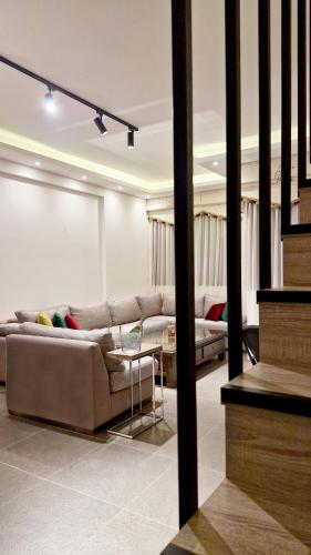 a living room with a couch and a table at White Bloom - Kfardebian 6836 in Kfardebian