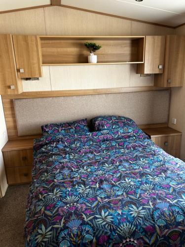 a bed with a colorful blanket on it in a room at Drake 17 in Scarborough