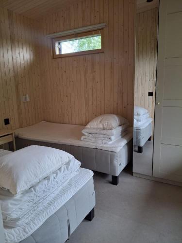 a room with two beds and a window at Cottage in Raahe in Raahe