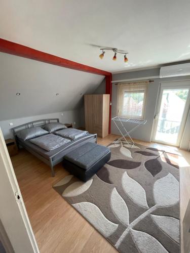a bedroom with a bed and a rug at Fefe Apartman in Balatonlelle