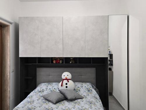 a bed with a hello kitty pillow on top of it at L'Officina in Leverano