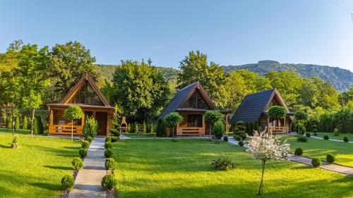 a home in the mountains with a green yard at Sicevacka Bajka log cabin in a nature park in Niš