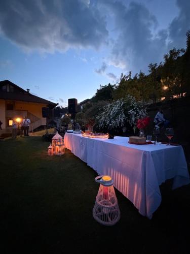 a long white table with lights on it at Hotel Sorriso in Ponte di Legno