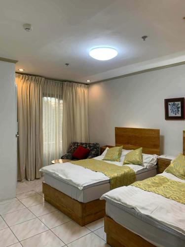 a bedroom with two beds and a window at Dream Garden Hotel in Solano