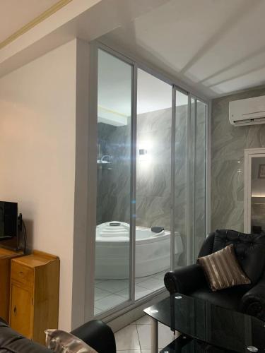 a living room with a glass window with a bath tub at Dream Garden Hotel in Solano