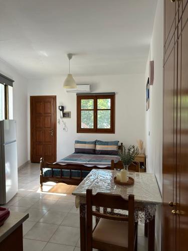 a living room with a table and a couch at SDROSOS Apartment in Kos