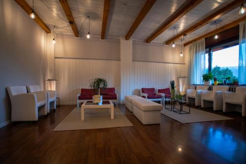 a waiting room with couches and a table at Hotel Latemar in Castello di Fiemme