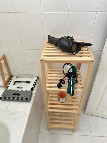 a wooden stand with a pair of glasses on it at appartement cozy in Kolea