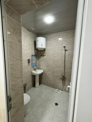 a bathroom with a toilet and a sink at STOP otel in Sheki