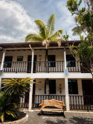a building with a palm tree in front of it at Hotel Ciudad de Segorbe in Salento