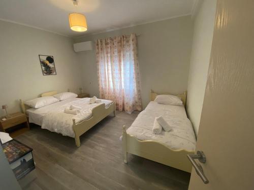 a bedroom with two beds and a window at Thassos Home in Skala Kallirachis