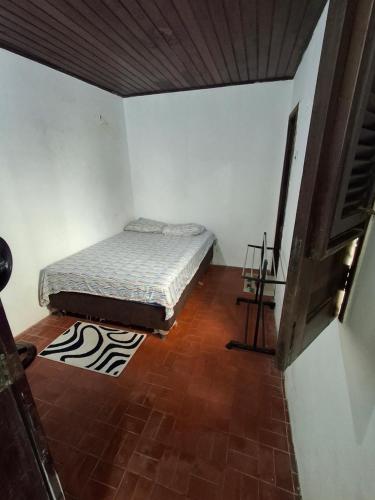 a bedroom with a bed and a wooden floor at Quarto Confortável no Centro - Bela Ilha House in São Luís