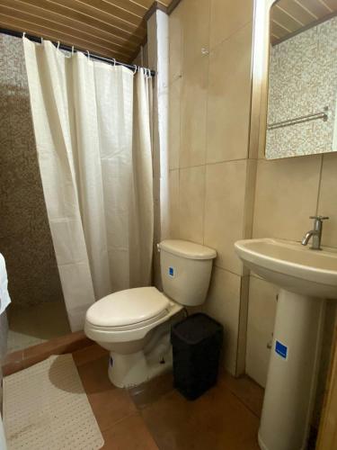 a bathroom with a toilet and a sink at La Villa Study & Relax Apartment in Los Santos