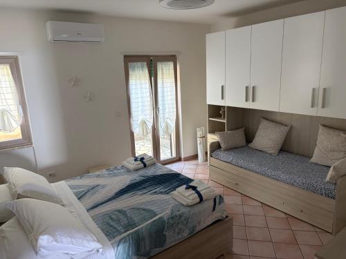 a bedroom with a bed and a couch in it at Villa Max in San Nicola Arcella
