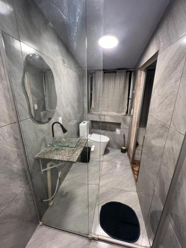 a bathroom with a shower with a sink and a toilet at Refúgio 4 in Belo Horizonte