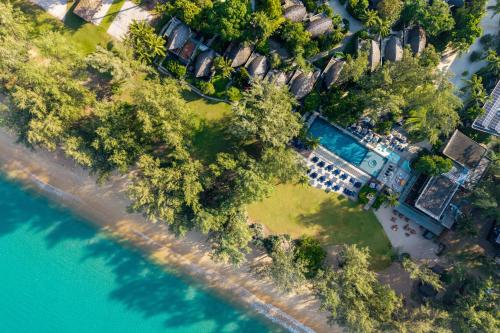 an aerial view of a beach with trees and water at Renaissance Phuket Resort & Spa in Mai Khao Beach