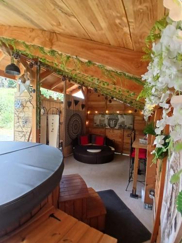 a room with a pool table and a couch at L'O Ré des Bois Hébergement insolite Aube, Bain, Sauna, Kota, Massages in Laussonne