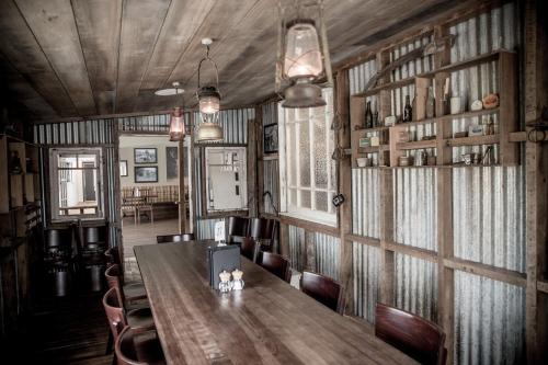 a dining room with a wooden table and chairs at The Harvest Hotel in Cromwell