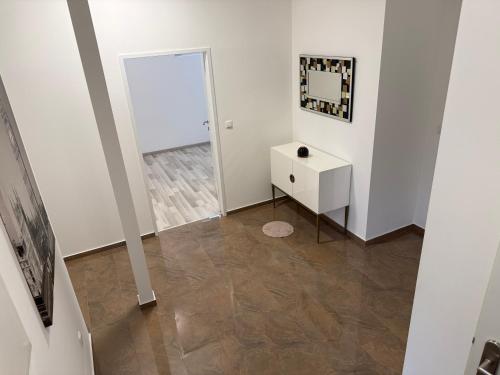 a white room with a white cabinet and a mirror at Komfortresidenz Harmonie in Weiz