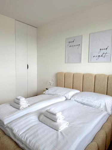 a bedroom with two beds with towels on them at Modra Sunny Apartment in Modra