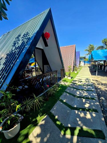 a house with a red ball on top of it at Laofoo Island Resort in Bued