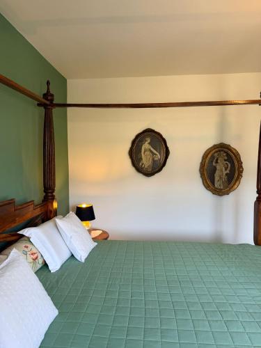 a bedroom with a bed with two pictures on the wall at Zimmer Room Trogir Kastela Split in Kaštela